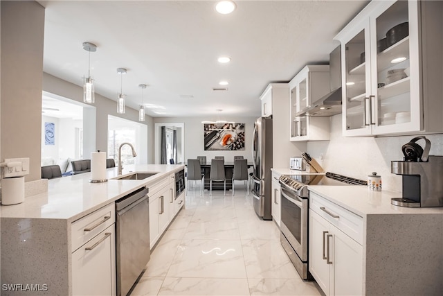 kitchen with white cabinetry, sink, pendant lighting, and appliances with stainless steel finishes