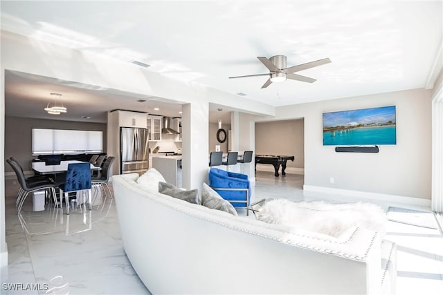 living room featuring ceiling fan and pool table