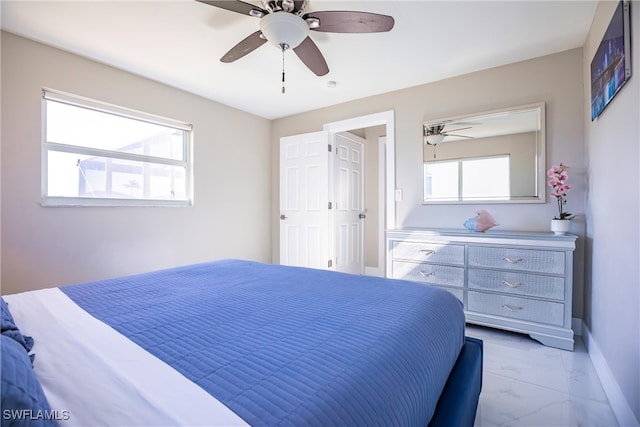 bedroom featuring ceiling fan and multiple windows