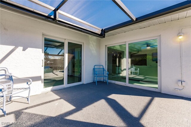 view of patio featuring glass enclosure