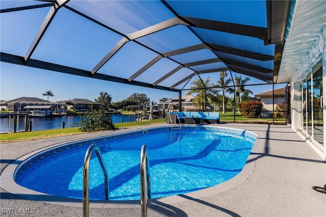 view of pool with a lanai, a water view, and a patio