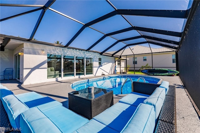 view of pool featuring outdoor lounge area, a patio area, and a lanai