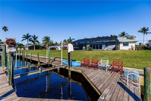 view of dock with a water view and a lawn