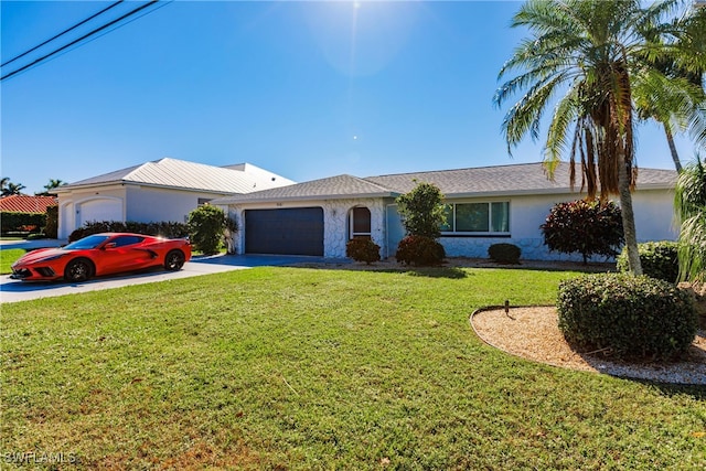 single story home featuring a garage and a front yard