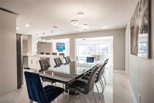 dining space featuring a textured ceiling and sink