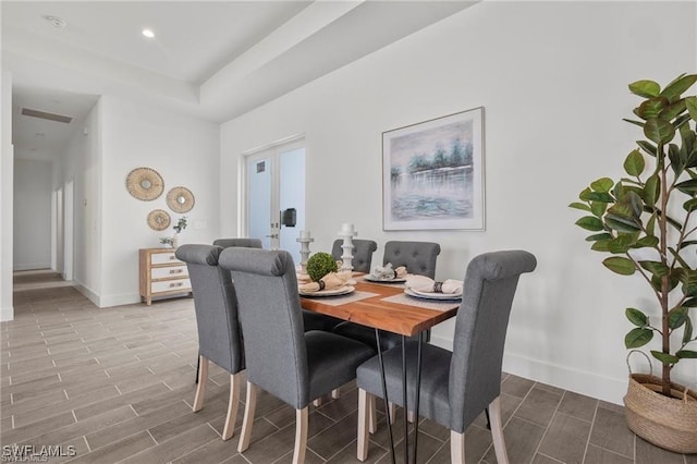 dining space with wood-type flooring