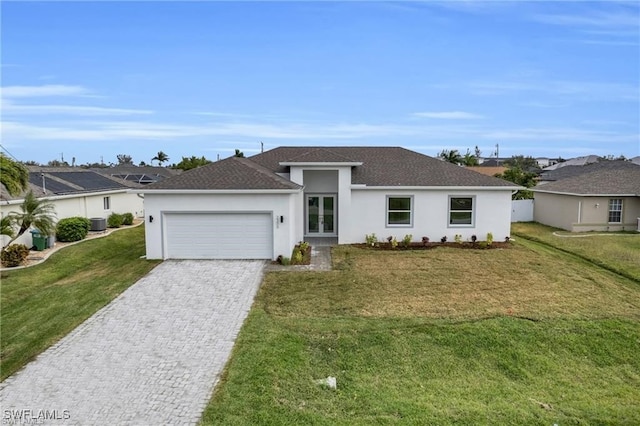 view of front of property featuring a front lawn, cooling unit, a garage, and french doors