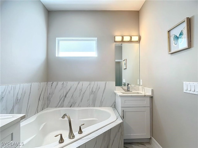 bathroom with vanity and tiled tub