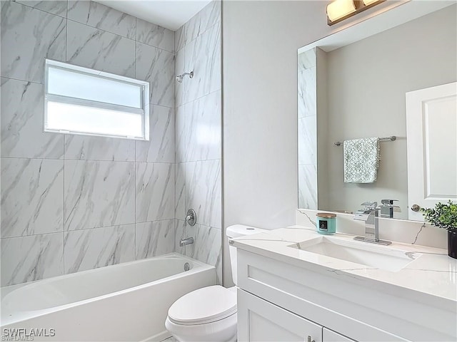 full bathroom featuring vanity, toilet, and tiled shower / bath