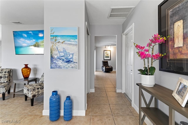 hall featuring light tile patterned floors