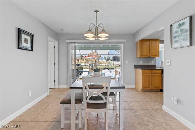 dining area with a notable chandelier and light tile patterned flooring