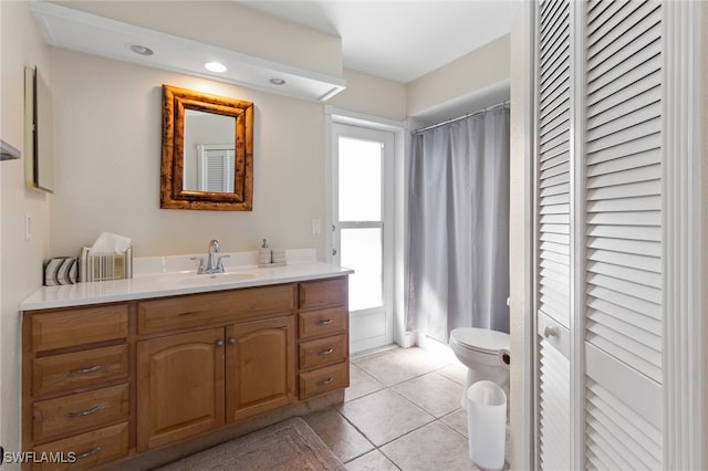 bathroom featuring tile patterned flooring, vanity, and toilet