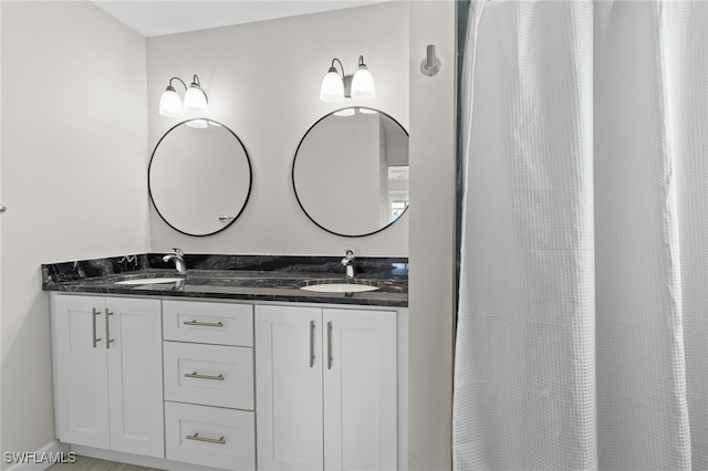 bathroom featuring vanity and curtained shower