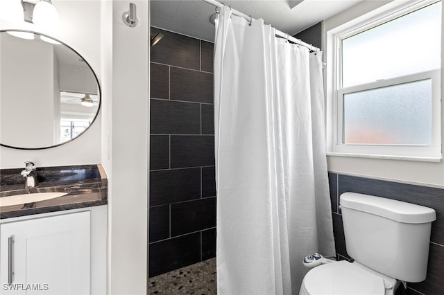 bathroom featuring toilet, vanity, and a shower with shower curtain