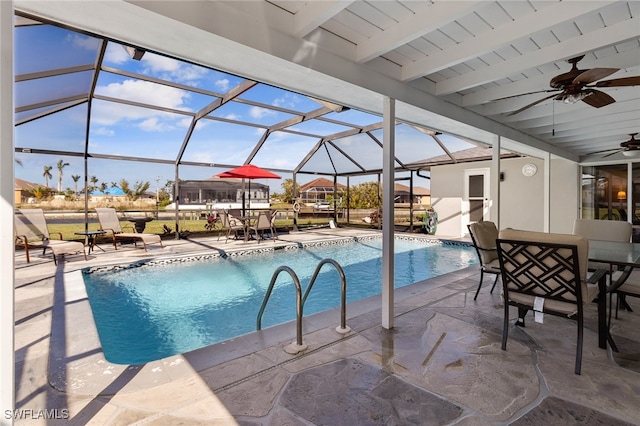 view of pool with a patio, glass enclosure, and ceiling fan