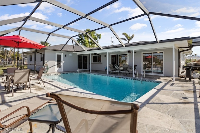 view of pool featuring a lanai, ceiling fan, a grill, and a patio area