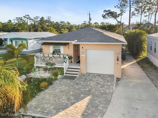 single story home featuring a garage and covered porch