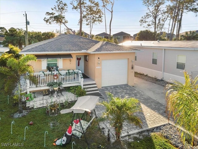 view of front facade with covered porch and a garage