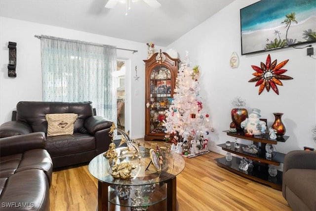 living room featuring ceiling fan and hardwood / wood-style flooring