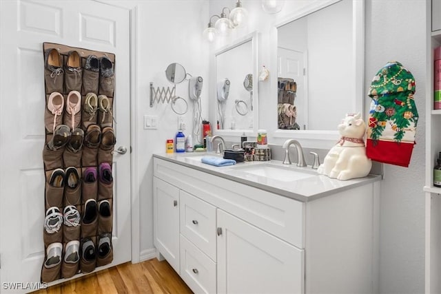 bathroom with hardwood / wood-style flooring and vanity