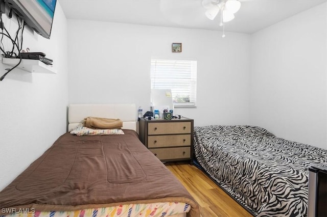 bedroom featuring light hardwood / wood-style flooring and ceiling fan