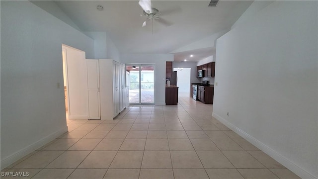 tiled empty room featuring ceiling fan and vaulted ceiling