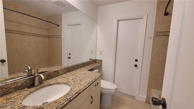 full bathroom with tile patterned flooring, vanity, toilet, and tiled shower / bath