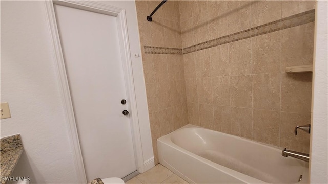 bathroom with tile patterned flooring, vanity, and tiled shower / bath combo