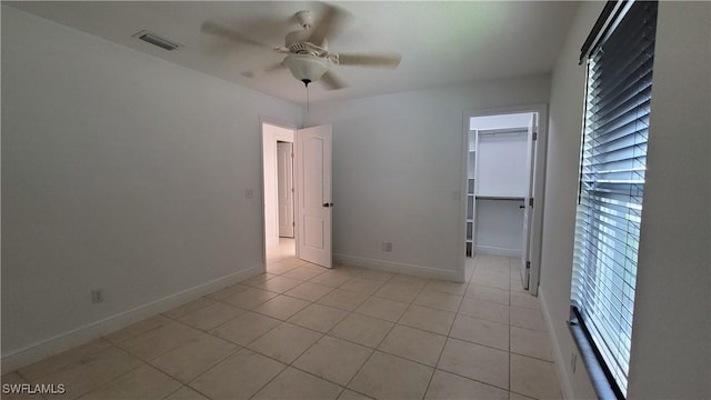 unfurnished room featuring light tile patterned floors and ceiling fan