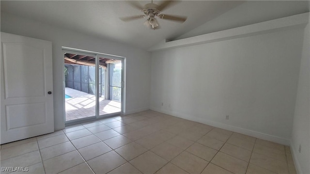 spare room featuring ceiling fan, light tile patterned floors, and lofted ceiling