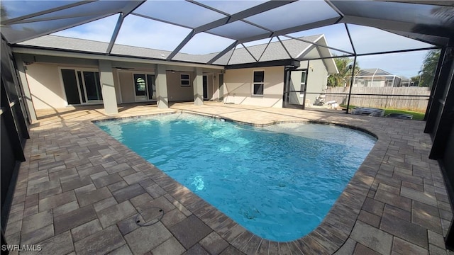 view of pool featuring a lanai, ceiling fan, and a patio