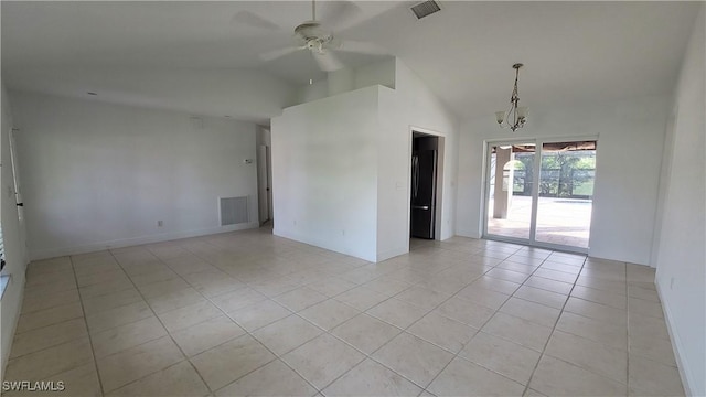 unfurnished room with ceiling fan with notable chandelier, light tile patterned floors, and vaulted ceiling