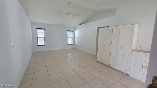 unfurnished bedroom featuring light tile patterned floors and vaulted ceiling