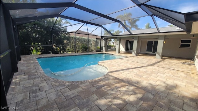 view of swimming pool featuring a patio, ceiling fan, and a lanai