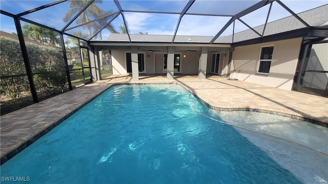 view of swimming pool with a patio, ceiling fan, and a lanai