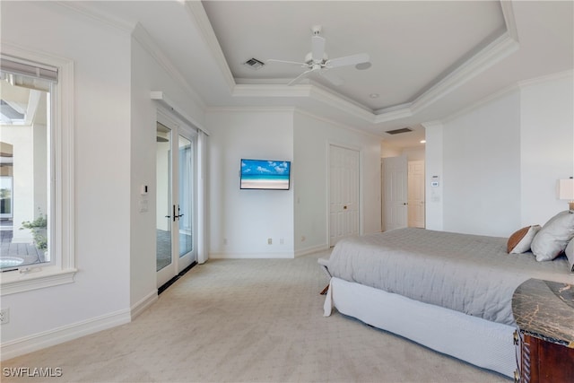 carpeted bedroom featuring a raised ceiling, ceiling fan, and crown molding