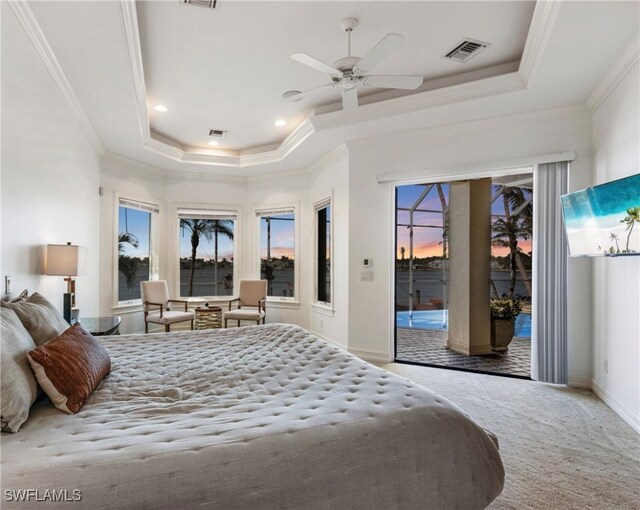 carpeted bedroom featuring access to outside, a raised ceiling, ceiling fan, and ornamental molding