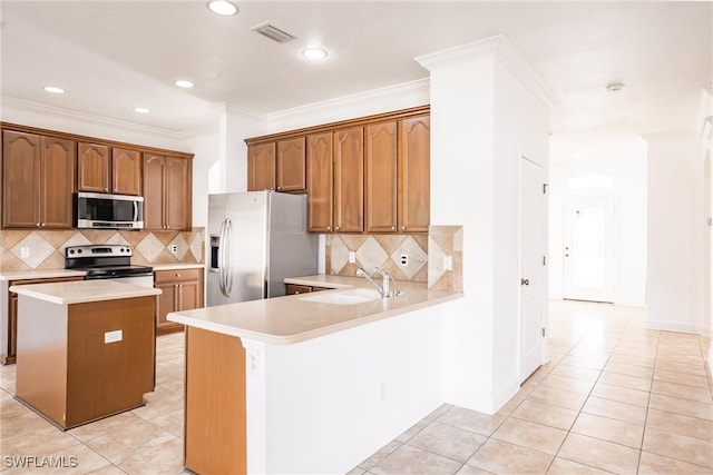 kitchen featuring sink, a center island, kitchen peninsula, light tile patterned floors, and appliances with stainless steel finishes