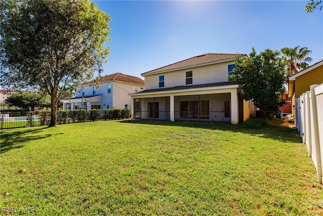 back of house featuring a lawn