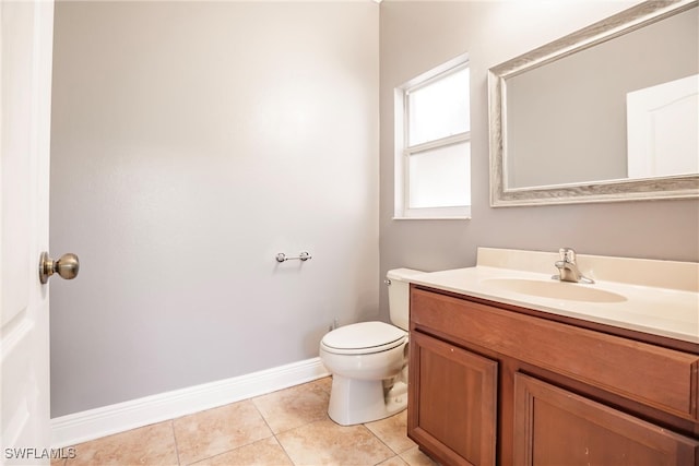 bathroom featuring toilet, vanity, and tile patterned floors