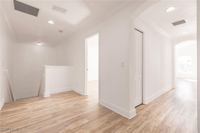 interior space featuring light hardwood / wood-style floors and crown molding