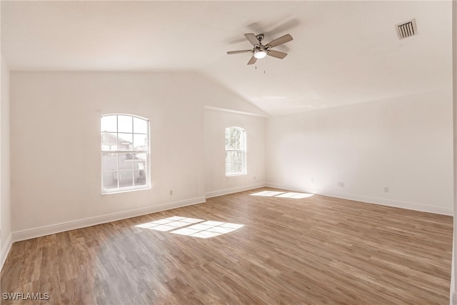 spare room featuring hardwood / wood-style flooring, ceiling fan, and vaulted ceiling