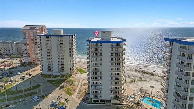 birds eye view of property with a water view and a beach view