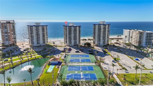 drone / aerial view with a water view and a beach view