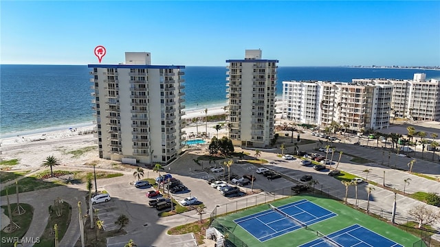 drone / aerial view featuring a water view and a view of the beach