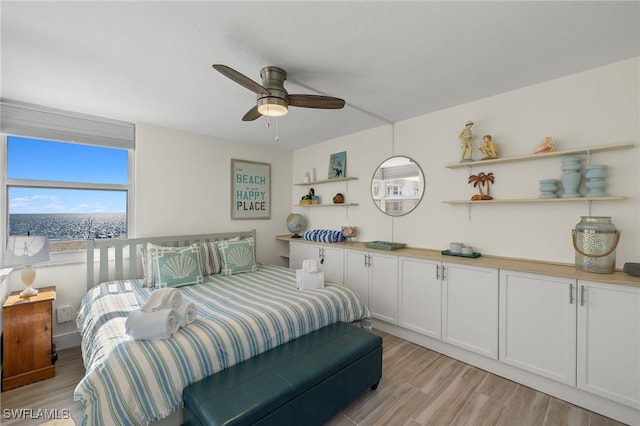 bedroom with ceiling fan and light hardwood / wood-style floors