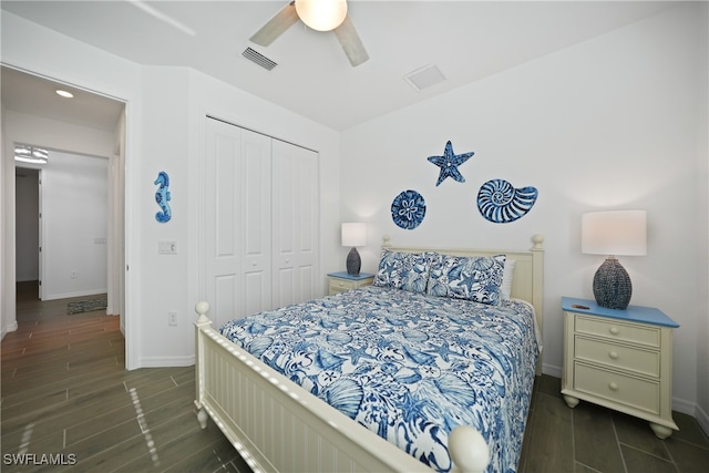 bedroom with ceiling fan, dark wood-type flooring, and a closet