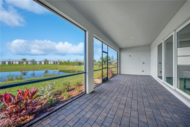 unfurnished sunroom with a water view