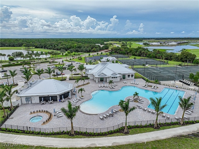 view of swimming pool featuring a water view