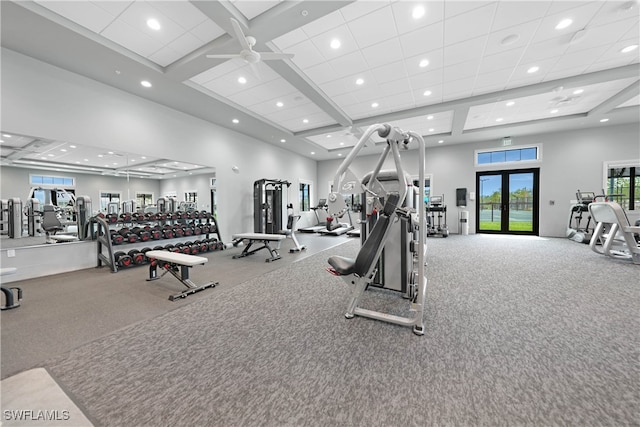 exercise room featuring carpet floors, a high ceiling, and french doors